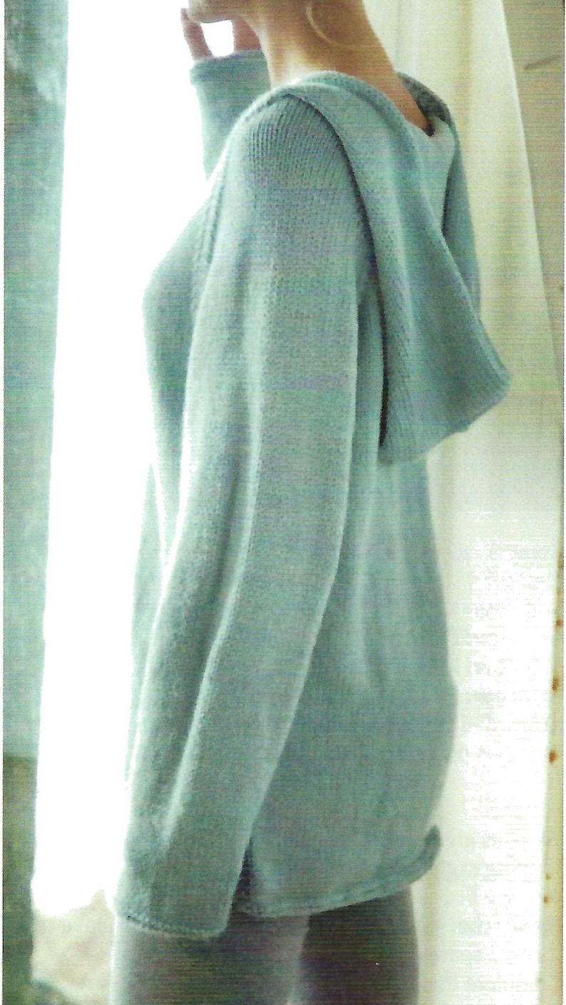 May include: A light blue hooded sweater with a relaxed fit. The sweater is made of a soft, knit fabric.