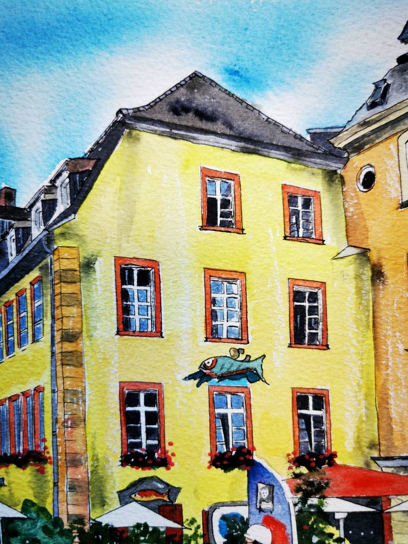 May include: Watercolor painting of a yellow building with red-framed windows and a dark gray roof. A blue fish-shaped sign is mounted on the wall. The sky is a light blue. The building is part of a European town.