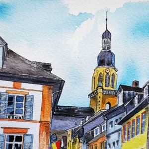May include: Watercolor painting of a European townscape with a tall church steeple. Buildings with orange, yellow, and blue accents line the street. Blue shutters and a light blue sky complete the scene.