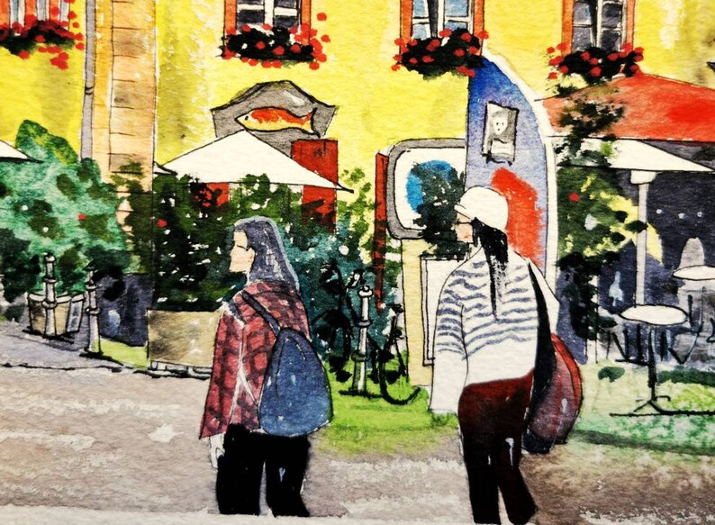 May include: Watercolor painting of a European street scene with two people walking. The buildings are yellow with red accents, and there are outdoor seating areas. The scene is filled with greenery and floral arrangements.