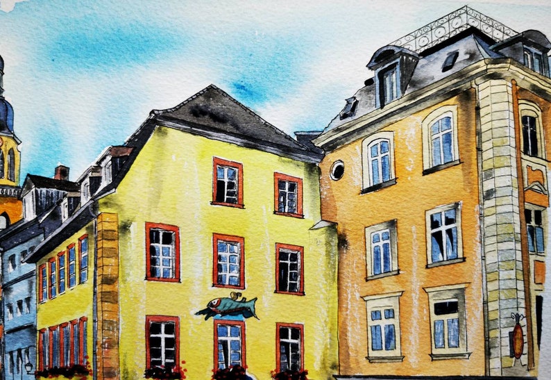 May include: Watercolor painting of European buildings with yellow and orange facades, red-framed windows, and dark gray rooftops. A blue sky is visible above the buildings. The painting style is loose and impressionistic, capturing the essence of the architecture.