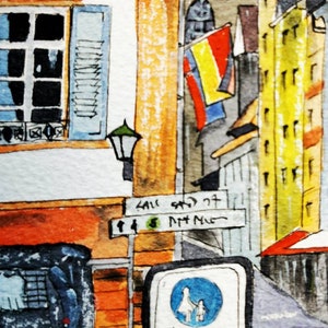 May include: Watercolor painting of a European street scene. Buildings in shades of orange, yellow, and gray. A street sign and a pedestrian zone sign are visible. The painting has a vintage, artistic style.