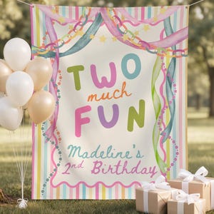 May include: A rectangular party banner featuring the text TWO much FUN Madeline's 2nd Birthday in colorful lettering, surrounded by watercolor illustrations of ribbons, chains, and stars, accompanied by a cluster of white and beige balloons.