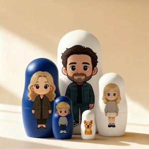 May include: A set of five nesting dolls with cartoon illustrations. The dolls feature a family and a dog. The largest doll is white with a man in a denim jacket. The second largest doll is blue with a woman in a coat.