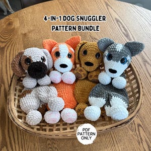 May include: A wicker basket contains four crocheted dog snugglers in different colours: white and brown, orange and white, tan, and grey and white. The text "4-IN-1 DOG SNUGGLER PATTERN BUNDLE" is at the top, and "PDF PATTERN ONLY" is at the bottom.