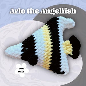 May include: A handmade crochet angel fish toy named "Arlo the Angelfish". The fish features a black, white, and yellow color scheme. The text "Arlo the Angelfish" is displayed at the top, and "PDF ONLY?" is at the bottom.
