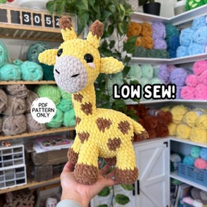May include: A handmade yellow and brown crochet giraffe with a gray muzzle and black eyes. The giraffe has brown spots and is labeled "LOW SEW!" and "PDF PATTERN ONLY".