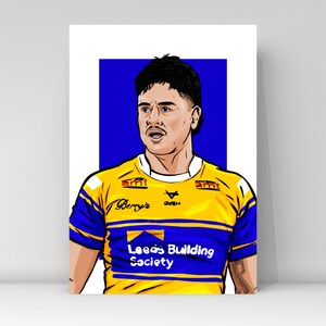May include: A digital illustration of a rugby player wearing a yellow and blue jersey with the text "Leeds Building Society" on the front. The jersey also has the text "Berry's" and "Oxen" on the front.