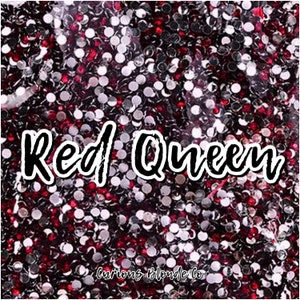 May include: Red Queen text in black script on a background of red and silver glitter.