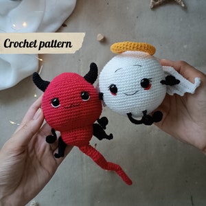 May include: Crochet pattern for a red devil and a white angel with a halo. Both figures have black eyes and a smiling mouth.