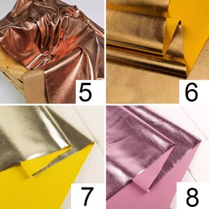 May include: Four swatches of metallic fabric in different colors: rose gold, gold, silver, and pink. The fabric is folded and shows the shiny metallic finish.