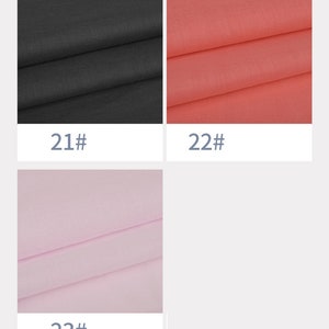 May include: Three fabric swatches, one black, one coral, and one light pink. The swatches are labelled with numbers 21, 22, and 23.