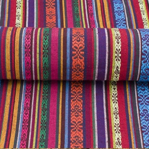 May include: Multicolored striped fabric with a woven pattern. The fabric is folded in half, showing the pattern on both sides.