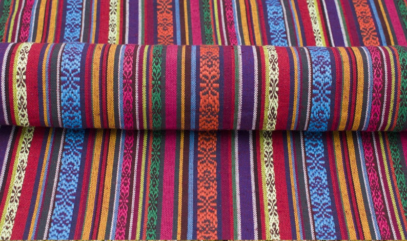 May include: Multicolored striped fabric with a woven pattern. The fabric is folded in half, showing the pattern on both sides.