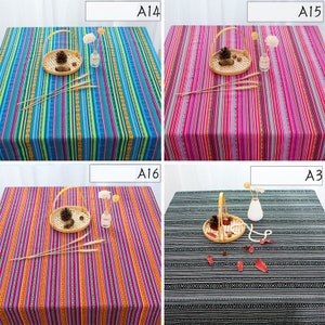 May include: Four different tablecloths with striped and geometric patterns. The tablecloths are in various colors, including blue, pink, orange, and black.
