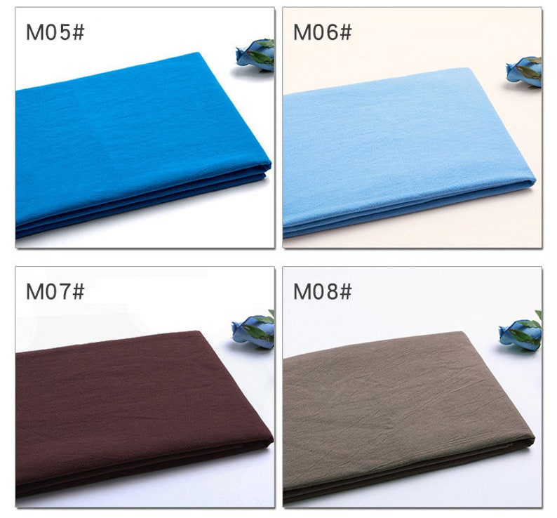 May include: Four fabric swatches in different colours: a bright blue, a light blue, a dark brown, and a light brown. The swatches are folded and laid out on a white surface. The swatches are labelled with the numbers M05, M06, M07, and M08.
