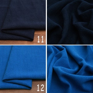 May include: Two fabric swatches, one dark blue and one royal blue. The fabric has a textured, woven appearance.