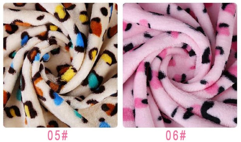 May include: Two fabric swatches with a leopard print pattern. The first swatch is a cream color with brown, yellow, blue, and green spots. The second swatch is pink with black spots. The swatches are labeled "05#" and "06#" respectively.