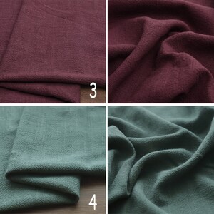 May include: Two fabric swatches, one a deep burgundy red and the other a muted teal green. Both fabrics have a textured, linen-like appearance.