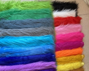May include: A selection of faux fur fabric swatches in a range of colours, including green, blue, purple, pink, red, orange, yellow, and white.