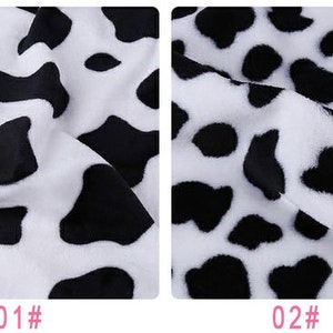 May include: Two close-up images of black and white cow print fabric. The first image shows a more textured fabric with a tighter pattern. The second image shows a smoother fabric with a larger pattern.