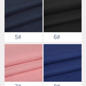 May include: Four fabric swatches in different colours. The swatches are arranged in a grid of two rows and two columns. The top left swatch is a dark blue fabric. The top right swatch is a black fabric. The bottom left swatch is a light pink fabric. The bottom right swatch is a dark blue fabric.