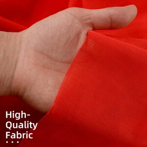 May include: Close-up of a bright red fabric, showing the texture and drape. The text "High-Quality Fabric..." is visible in the bottom left corner.