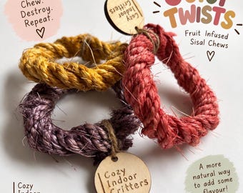 May include: Three circular sisal rope chews in yellow, red, and purple, each featuring a small round wooden tag engraved with the text Cozy Indoor Critters. The image includes text reading Juicy Twists, Twist. Chew. Destroy. Repeat., and A more natural way to add some flavour!