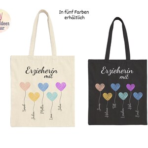 May include: Two tote bags, one cream and one black, each with the German text "Erzieherin mit" and colorful heart-shaped balloons. The cream bag has names below the balloons. The black bag also has names below the balloons. The text "In f&uuml;nf Farben erh&auml;ltlich" is at the top.