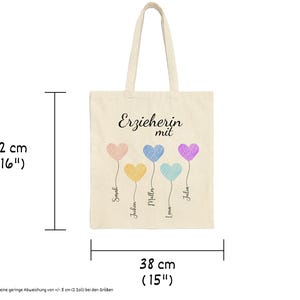 May include: A beige tote bag, 16 inches tall and 15 inches wide, with the German text "Erzieherin mit" and five colorful heart balloons. Each balloon has a name written below it.