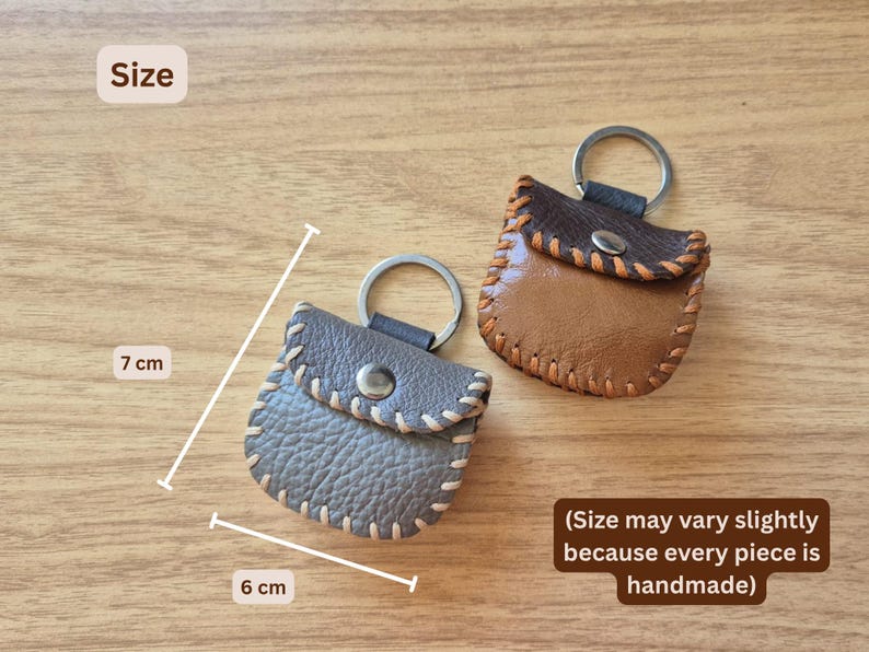 May include: Handmade leather keychains in brown and gray, each measuring approximately 2.4 inches wide and 2.8 inches tall. The keychains feature a stitched design and a metal keyring. The text on the image says "Size may vary slightly because every piece is handmade."