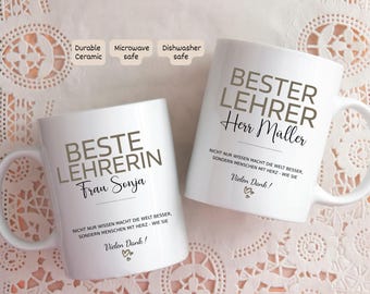 May include: Two white ceramic mugs with black text. One mug says "BESTE LEHRERIN Frau Sonja" and the other says "BESTER LEHRER Herr Müller". Both mugs have a message in German and a heart symbol. The mugs are durable, microwave and dishwasher safe.