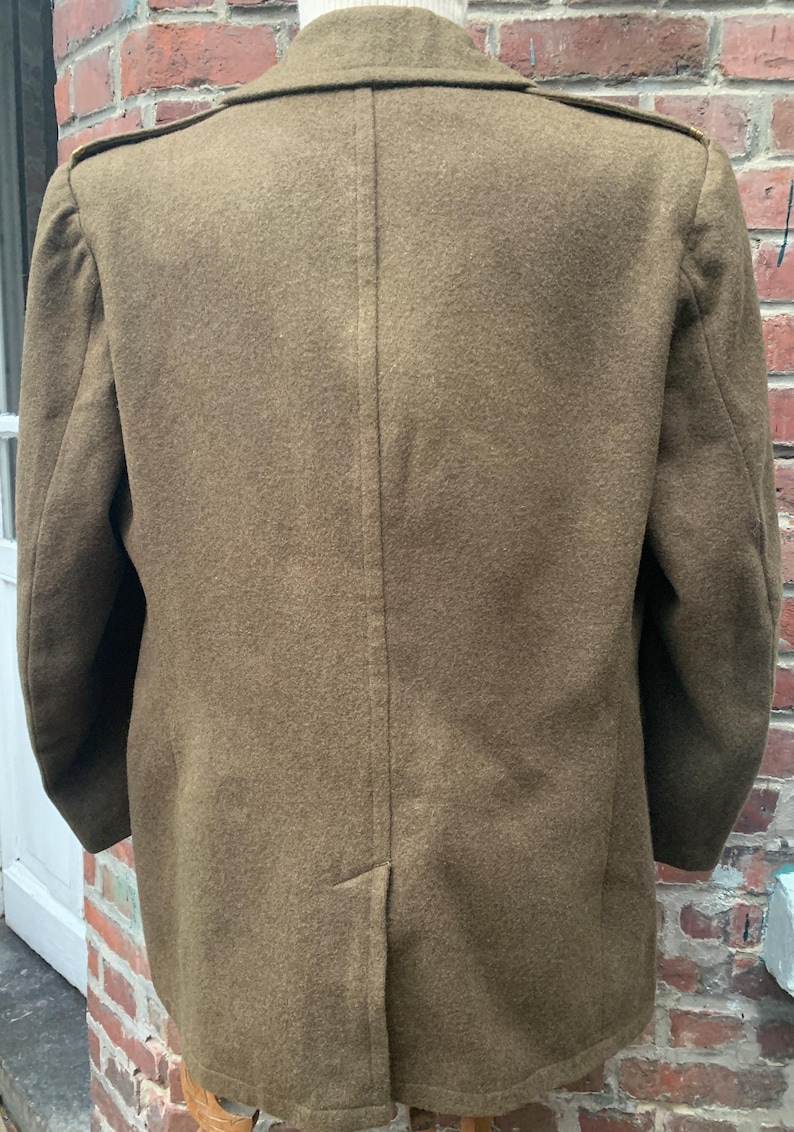 May include: A brown wool jacket with a double-breasted closure and a single back vent.