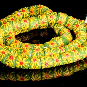 Recycled Glass Beads from Ghana - green with orange and yellow sunburst pattern - M00355