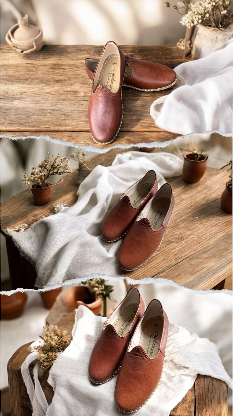 May include: A pair of brown leather slip-on shoes featuring a rounded toe, a low-cut topline, and visible light-colored stitching along the sole. The interior of the shoe includes a printed logo and text that reads "Handmade Fashion".