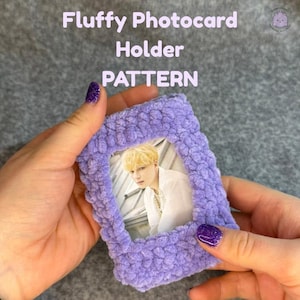 May include: A handmade, fluffy lavender photocard holder with a photo of a person with blonde hair. The text "Fluffy Photocard Holder PATTERN" is displayed at the top. The holder is held by a person with purple glitter nail polish.