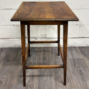 May include: A rustic wooden sign with the text "Welcome to our home" in white lettering. The sign features a distressed finish and a simple, inviting design, perfect for a front porch or entryway.