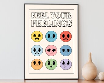 May include: A white poster with the text "Feel Your Feelings" in black lettering. The poster features nine colorful cartoon faces with different expressions.