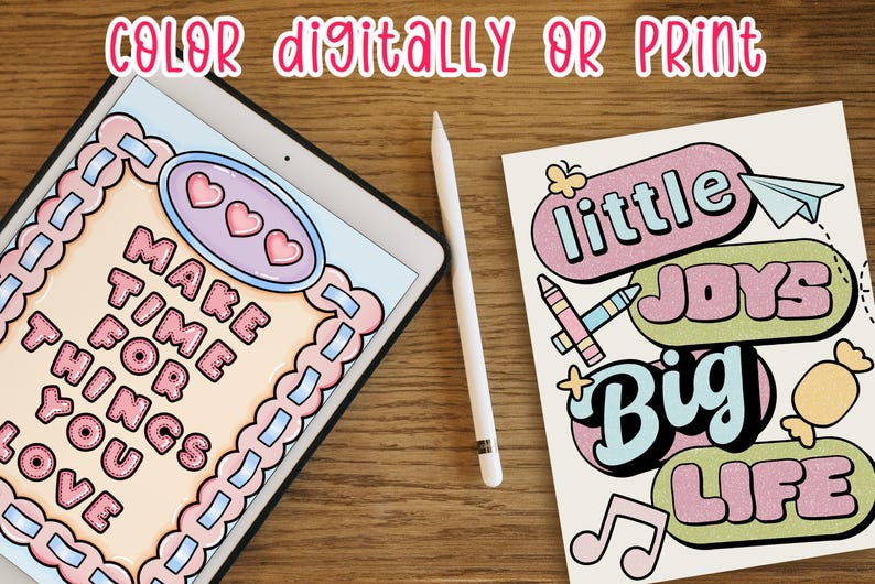 May include: An iPad displays a digital coloring page with the text "MAKE TIME FOR THINGS YOU LOVE" in pink bubble letters. A white stylus and a paper with the words "little joys, big life" are also present.