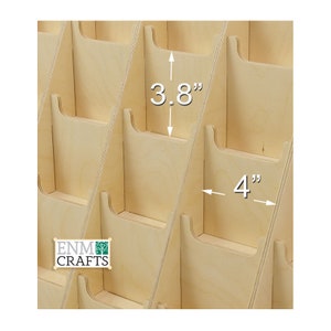 May include: A wooden card holder with 3.8 inch tall slots and 4 inch wide slots. The card holder is made of natural wood and has a light brown color.