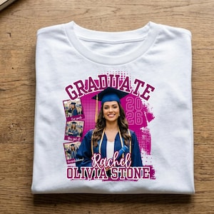 May include: White t-shirt with a graduation design. The design features a photo of a woman in a graduation cap and gown, the word "GRADUATE", the year "2026", and the name "Rachel Olivia Stone" in a magenta color.