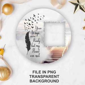 May include: A white circle with a photo frame, a feather, and birds flying upwards. The text reads "Your Wings were Ready but my Heart was not".