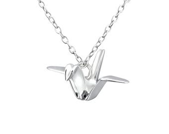 May include: A silver necklace with a delicate origami crane pendant. The crane is a symbol of peace and good luck.