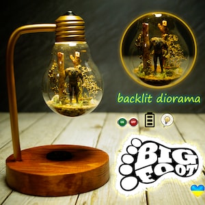 Bigfoot diorama. Miniature diorama of Bigfoot in a lamp. Diorama with illumination