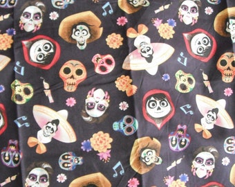 May include: Black fabric with a repeating pattern of colorful Day of the Dead sugar skulls, musical notes, and cartoon characters from the movie Coco. The characters are wearing sombreros and traditional Mexican clothing.