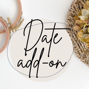 May include: A white circle with a black outline and the text "Date add-on" in a handwritten font. The circle is on a white background with two wooden embroidery hoops and a woven basket with dried flowers.