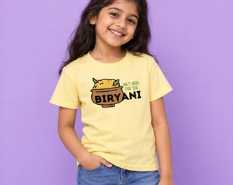 May include: A light yellow short-sleeved t-shirt featuring a graphic of a brown bowl filled with yellow food and green leaves. The text reads "ONLY HERE FOR THE BIRYANI" in black and green lettering, centered on the chest of the garment.