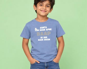 May include: A light blue short-sleeved t-shirt featuring white and grey text that reads SUNTA TOH MAIN APNE BAAP KI BHI NAHI HOON. The shirt has a crew neckline and is paired with blue denim jeans, creating a casual look for a young individual.