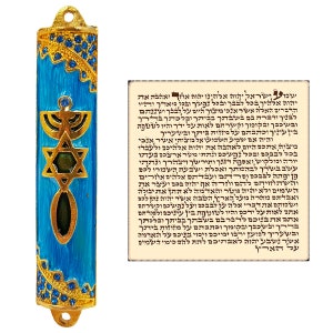 May include: A blue and gold mezuzah with a Star of David and menorah design. The mezuzah is decorated with rhinestones. The text on the scroll reads: "Shema Yisrael Adonai Eloheinu Adonai Echad."