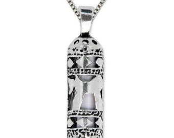 May include: A silver necklace with a detailed pendant shaped like a scroll. The pendant has an intricate design with cutouts and a textured surface.